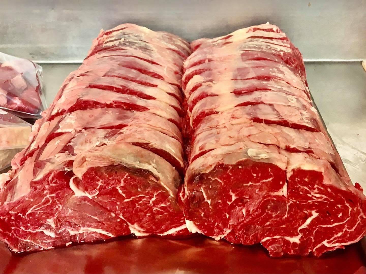 Freshly butchered 3 Bears Farm scotch fillet steaks, sliced to show their rich marbling